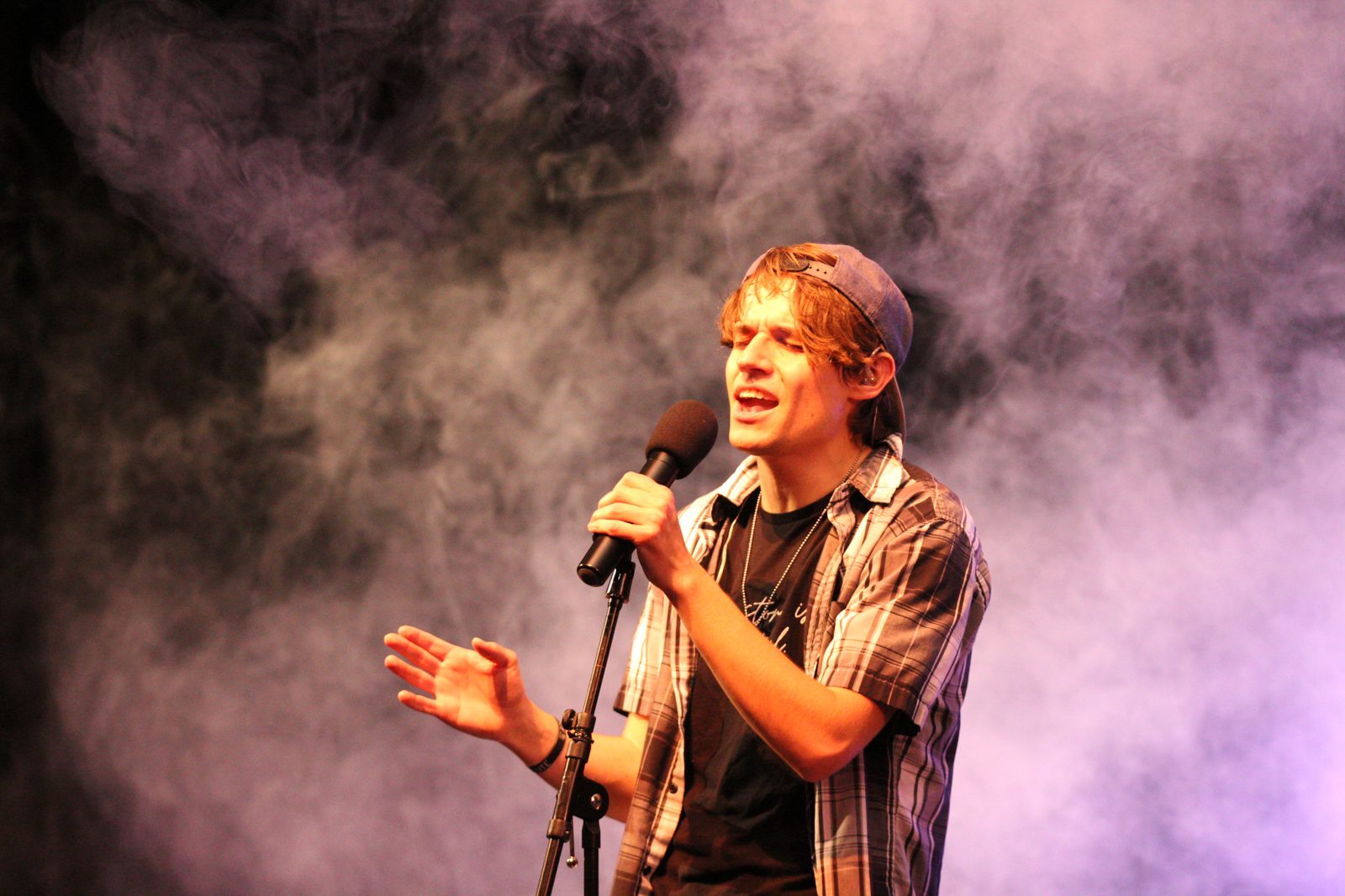 Jesse singing through stage smoke
